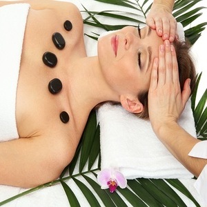image of woman doing hot stone massage